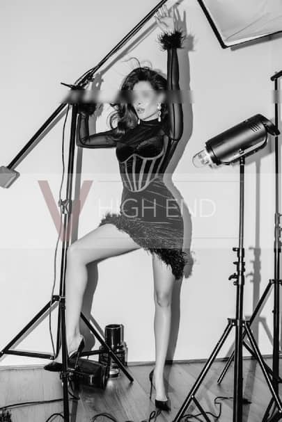 Ada, a hot brunette girl, in a short tight dress playing with photo equipment