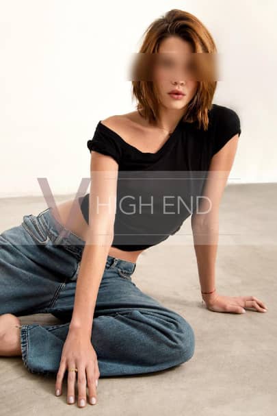 Top companion Lottie is sitting down in a black t-shirt and jeans