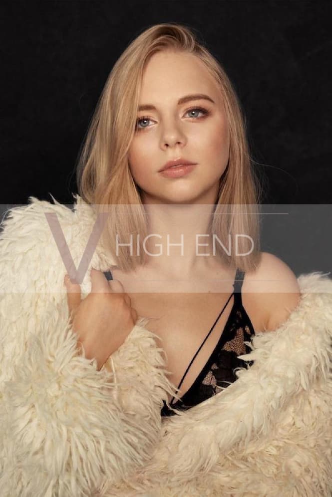 High End escort Liliana is holding her furry jacket around shoulders