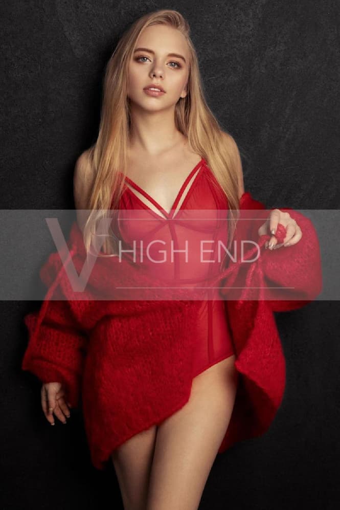 Vip model Liliana is posing in a red bodysuit and jumper