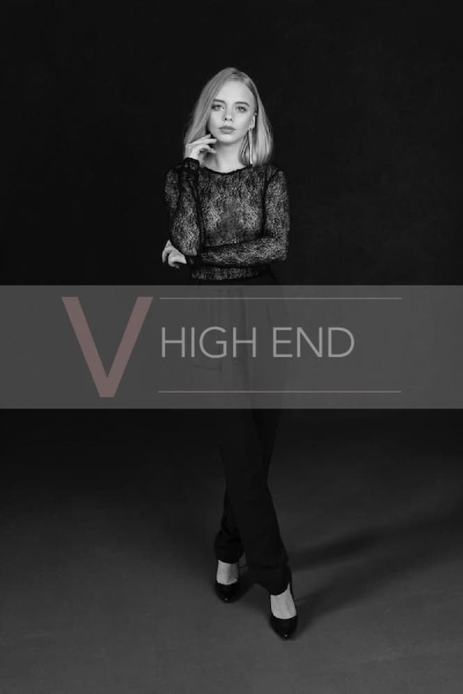 White and black photo of blonde escort Liliana wearing all black