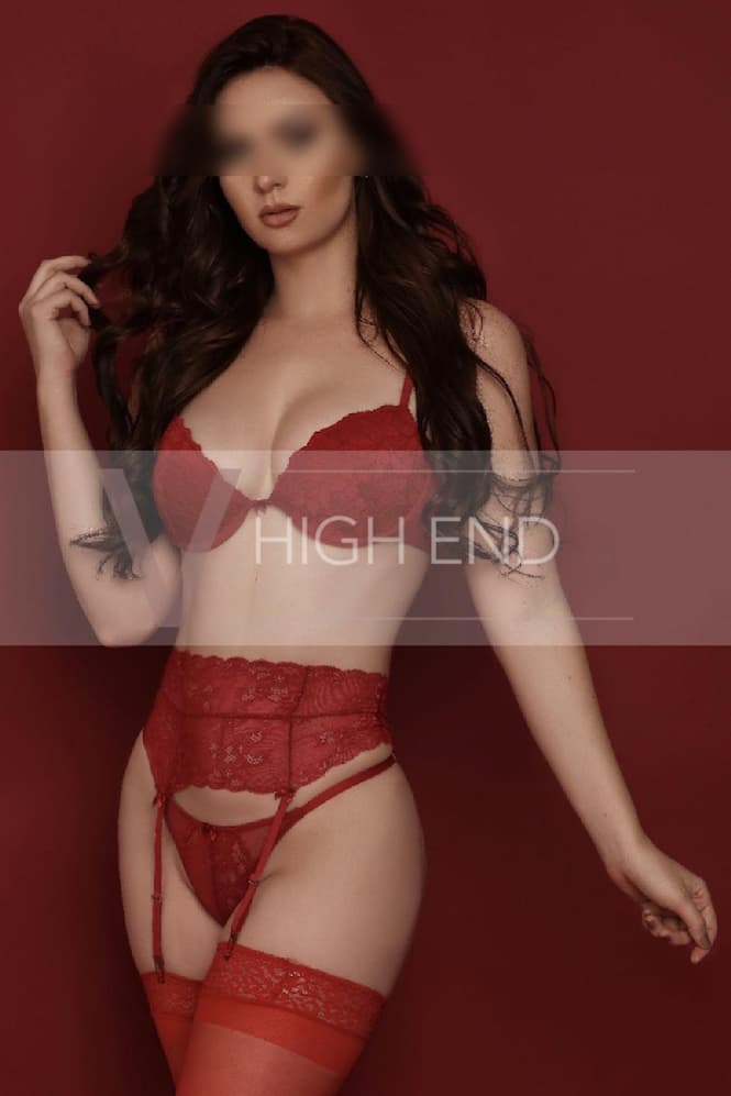 London companion Celina dressed in red matching lingerie with a suspender belt and stockings