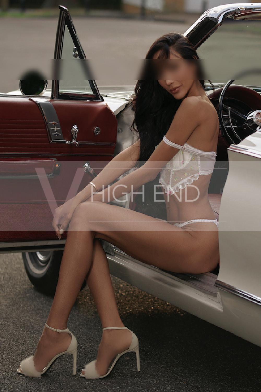 Elite model Thalia is posing in a silver bra and high heels boots and lingerie