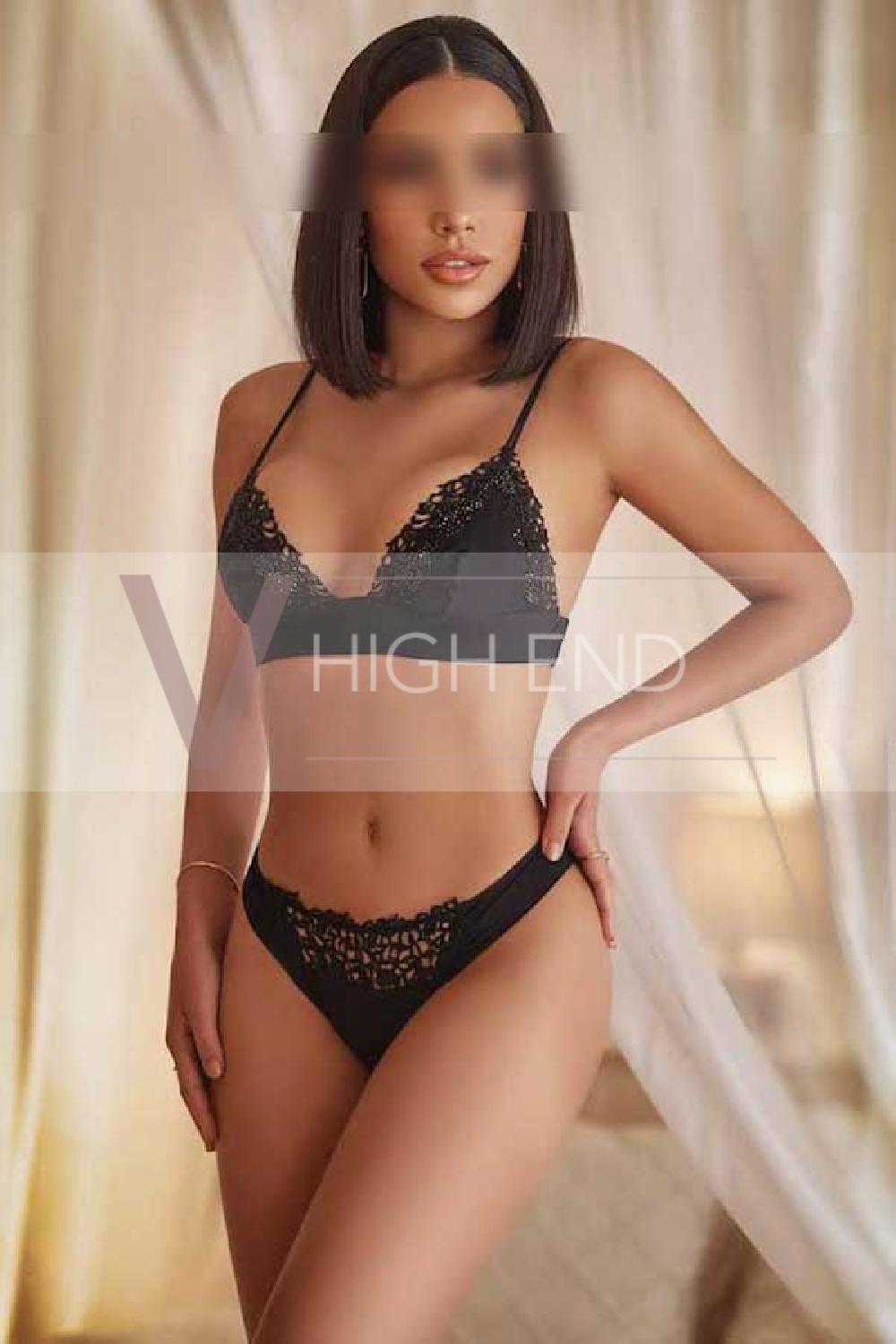 Hot brunette escort Iza is posing in a black lingerie 